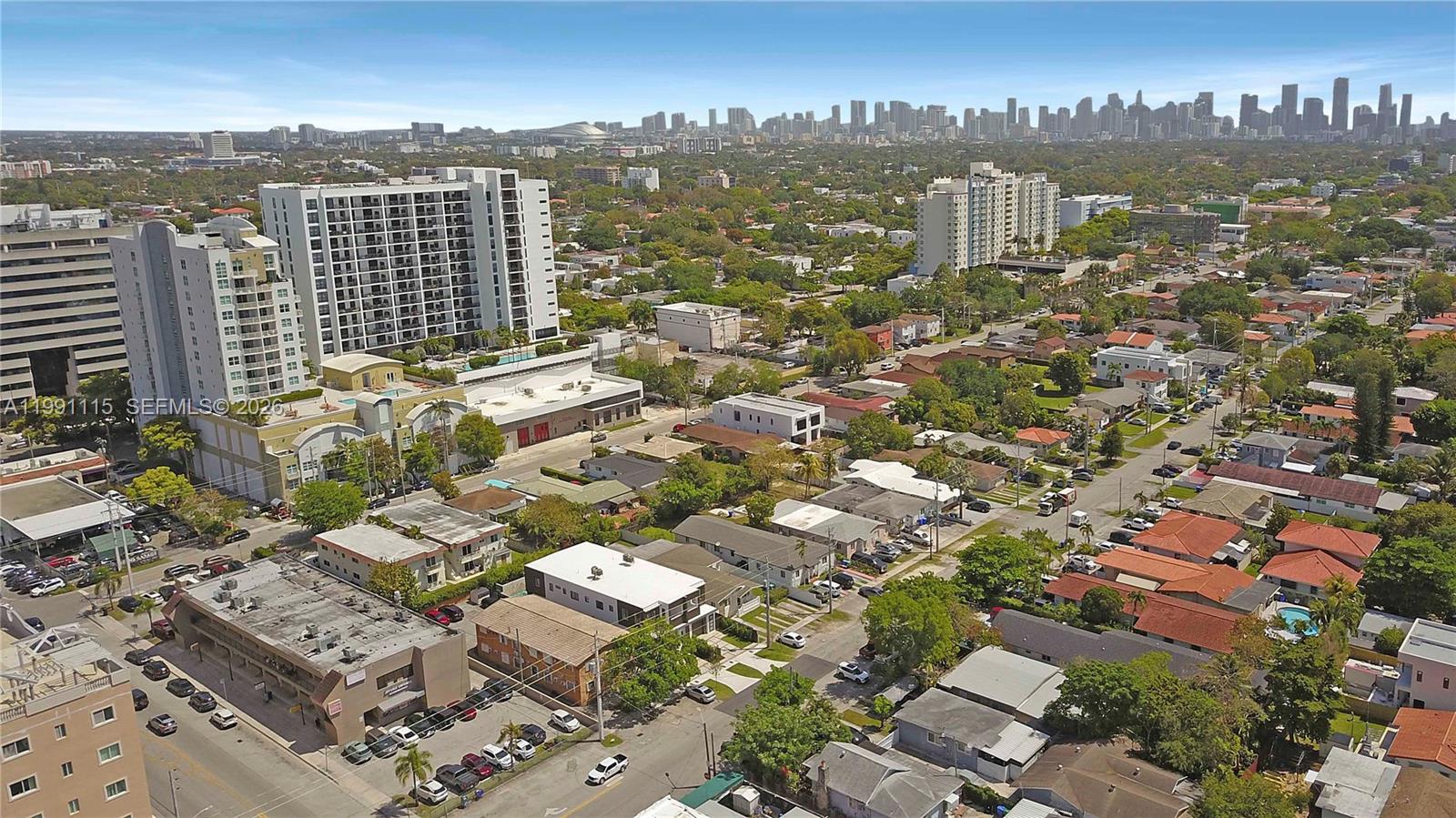 An aerial view shows a residential neighborhood with apartment buildings and houses under a blue sky — 3191 SW 23rd St, Miami FL 33145, MIAMI, FL
