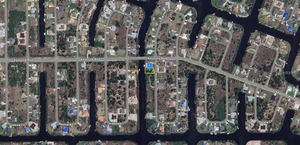 This is an aerial map view of a residential neighborhood with canal-front lots — 9676 ARNAZ CIRCLE, PORT CHARLOTTE, FL