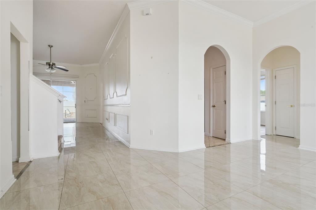 The exterior of a house features a tan facade, a garage, and a front entryway — 1900 ACACIA DRIVE, KISSIMMEE, FL
