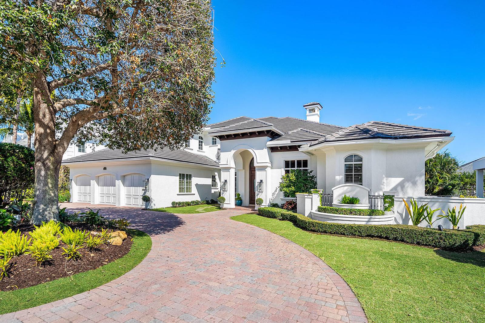 A white stucco house with a tiled roof and a brick driveway under a tree — 2310 W Silver Palm Road, Boca Raton FL 33432, BOCA RATON, FL