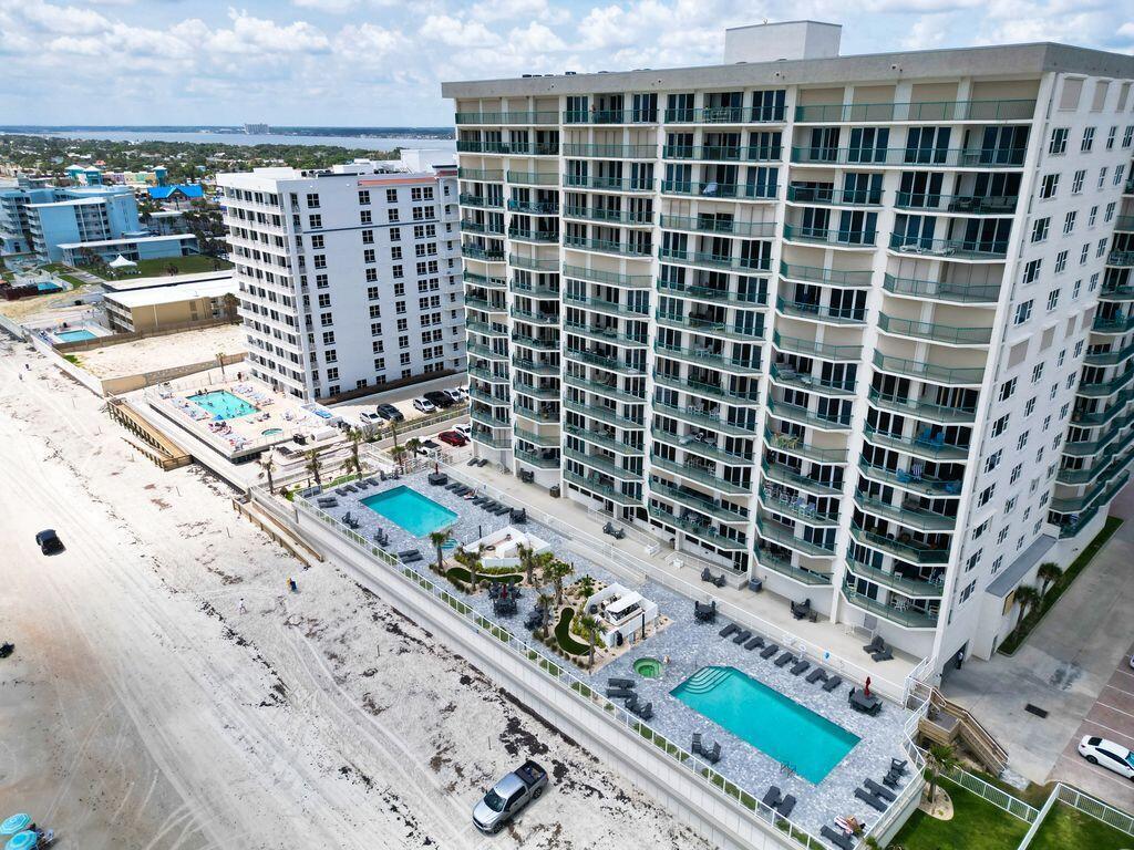 An aerial view of two high-rise beachfront condominium buildings with multiple swimming pools and decks — 2055 S Atlantic Avenue # 1410, FL 32118, FL