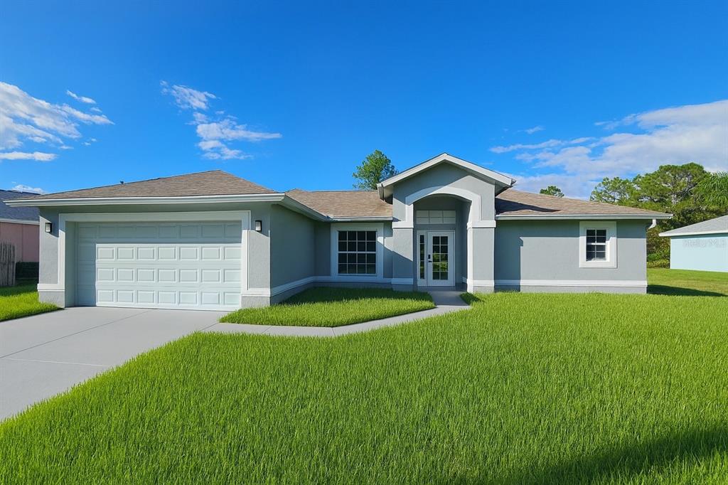 A single-story house with a gray stucco exterior, a two-car garage, and a front lawn — 116 RIDGEMONT DRIVE, LEHIGH ACRES, FL