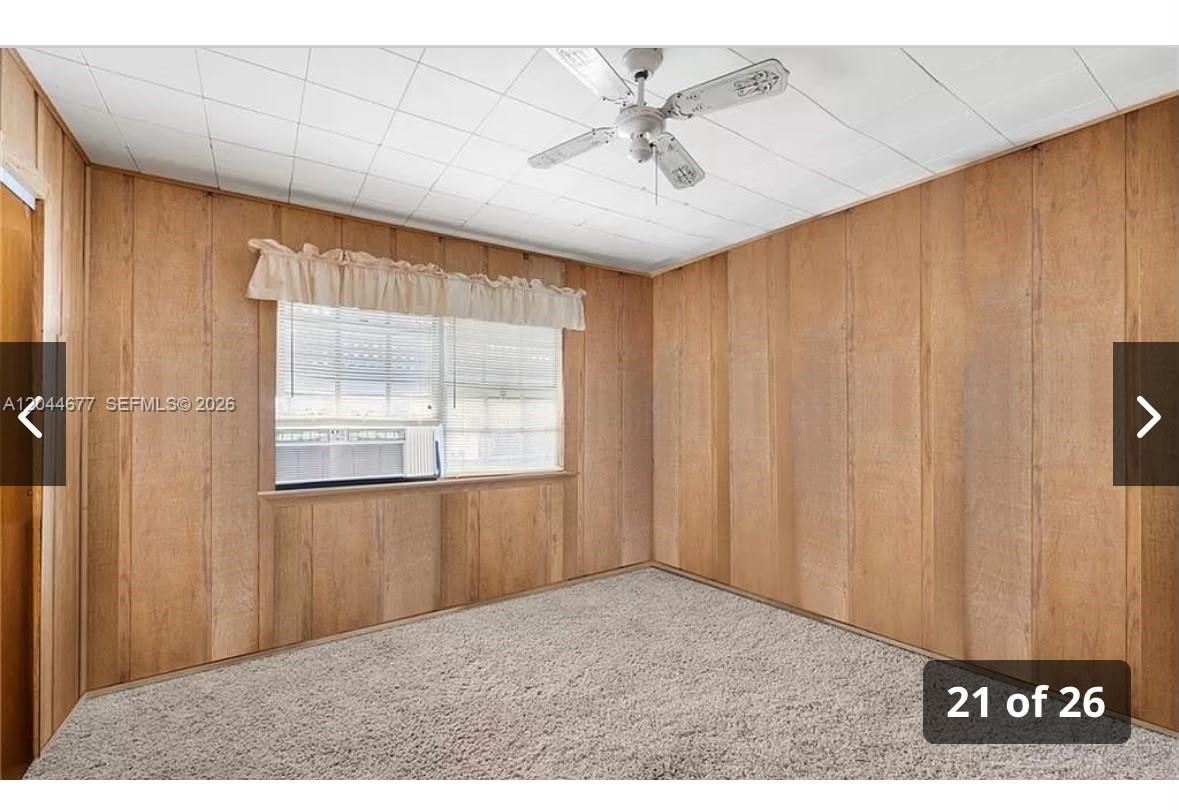 A bedroom with wood-paneled walls, a white drop ceiling, and gray carpet — 4210 CINDY, Naples FL 34112, NAPLES, FL