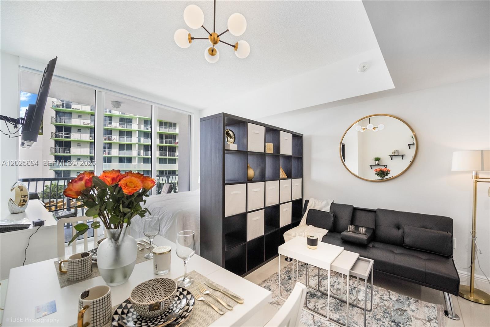 A studio apartment features a dining area, a living space with a sofa, and a partition — 1750 N Bayshore Dr # 1219, Miami FL 33132, MIAMI, FL