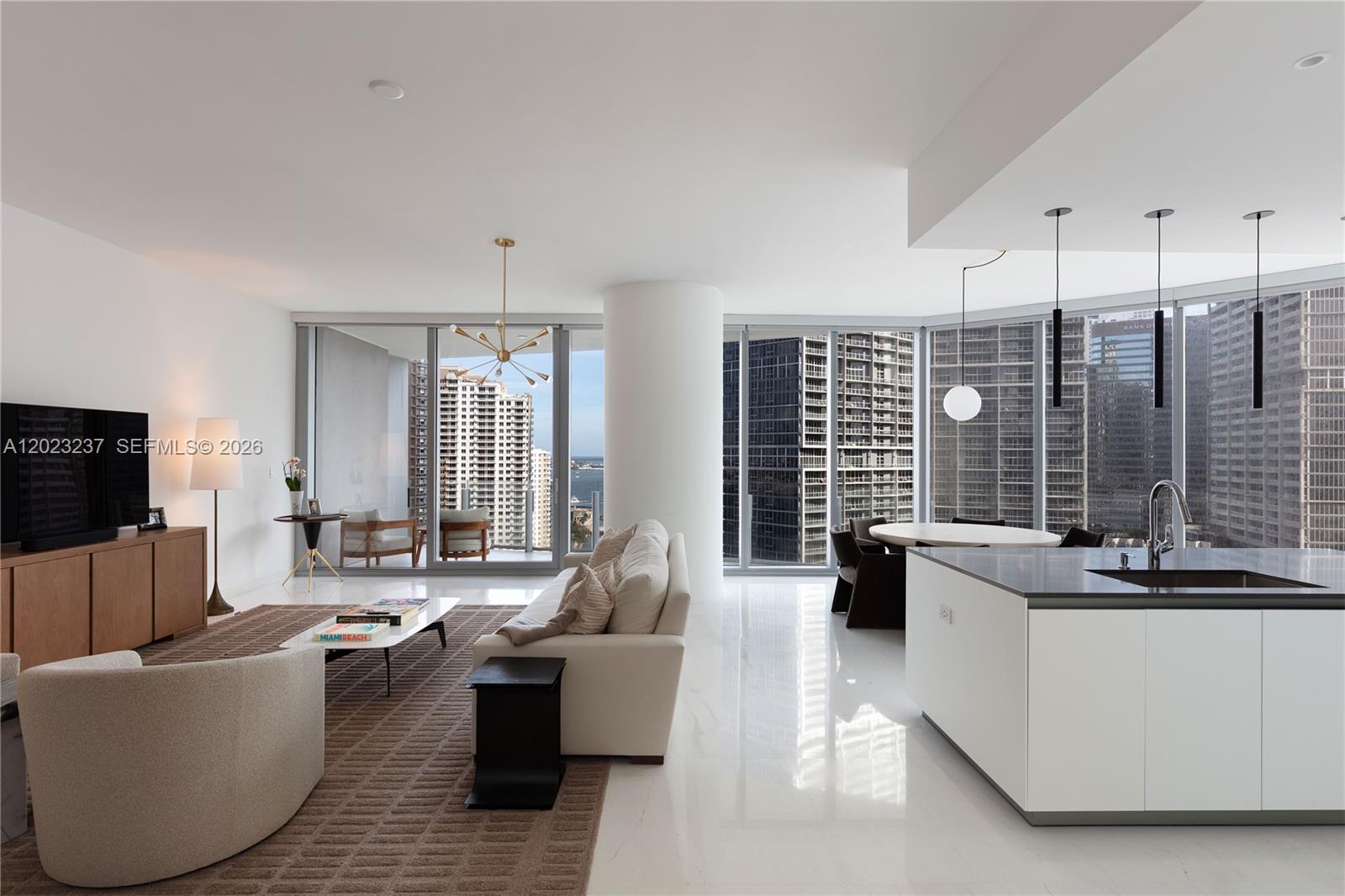 A modern open-concept living room and kitchen with floor-to-ceiling windows and white marble floors — 300 S Biscayne Blvd Way # 2107, Miami FL 33131, MIAMI, FL