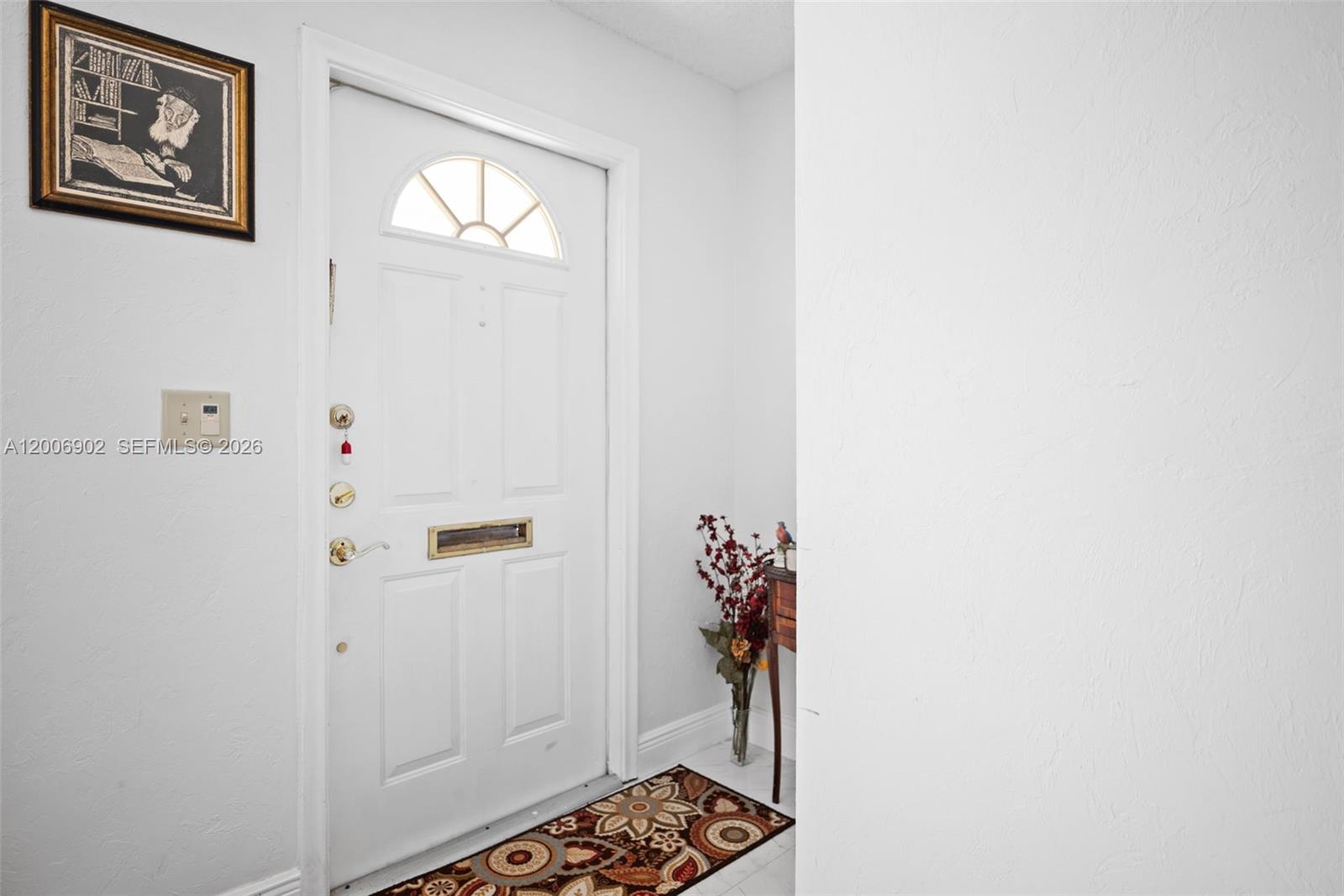 A white front door with a glass transom window opens into a small entryway — 2103 SW 20th Cir, Boynton Beach FL 33426, BOYNTON BEACH, FL
