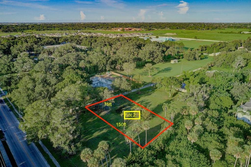 An aerial view shows a rectangular plot of land marked as Lot 2 with dimensions — 2619 16TH AVENUE DRIVE E, BRADENTON, FL