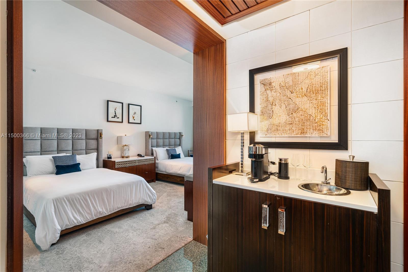 A hotel room features two beds, a kitchenette with a sink, and modern wood finishes — 10295 Collins Ave # 1216, Bal Harbour FL 33154, BAL HARBOUR, FL