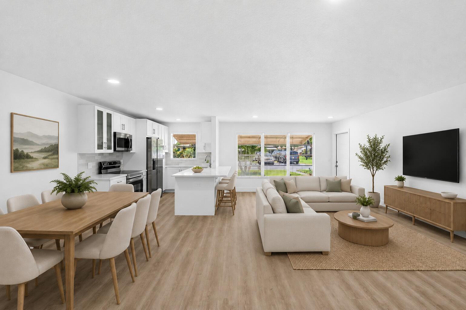 This open-concept living area features a modern kitchen, dining space, and lounge with light flooring — 1007 South Drive, Delray Beach FL 33445, DELRAY BEACH, FL