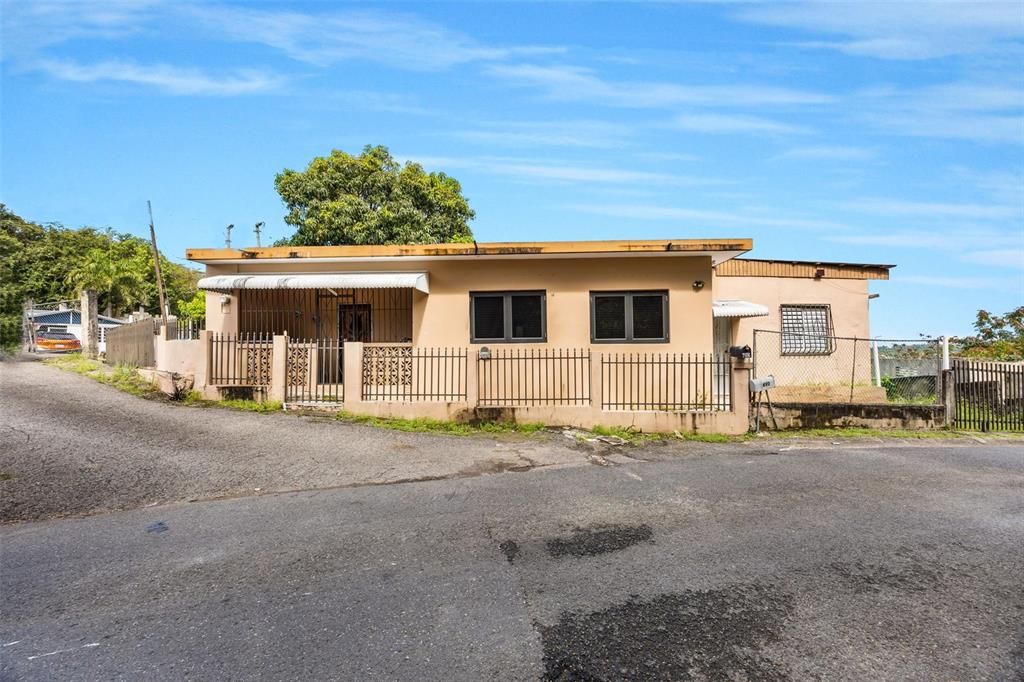 A room with wood-paneled walls, a central glass door, and two windows overlooking a landscape — BO Rio Hondo SOLAR 6, PR, PUERTO RICO,00680, MAYAGUEZ, PR