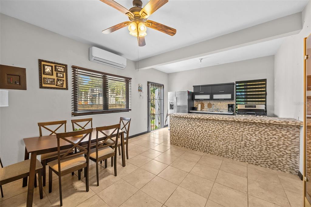 A dining area with a tiled floor and a kitchen featuring a tiled breakfast bar — BO Rio Hondo SOLAR 6, PR, PUERTO RICO,00680, MAYAGUEZ, PR
