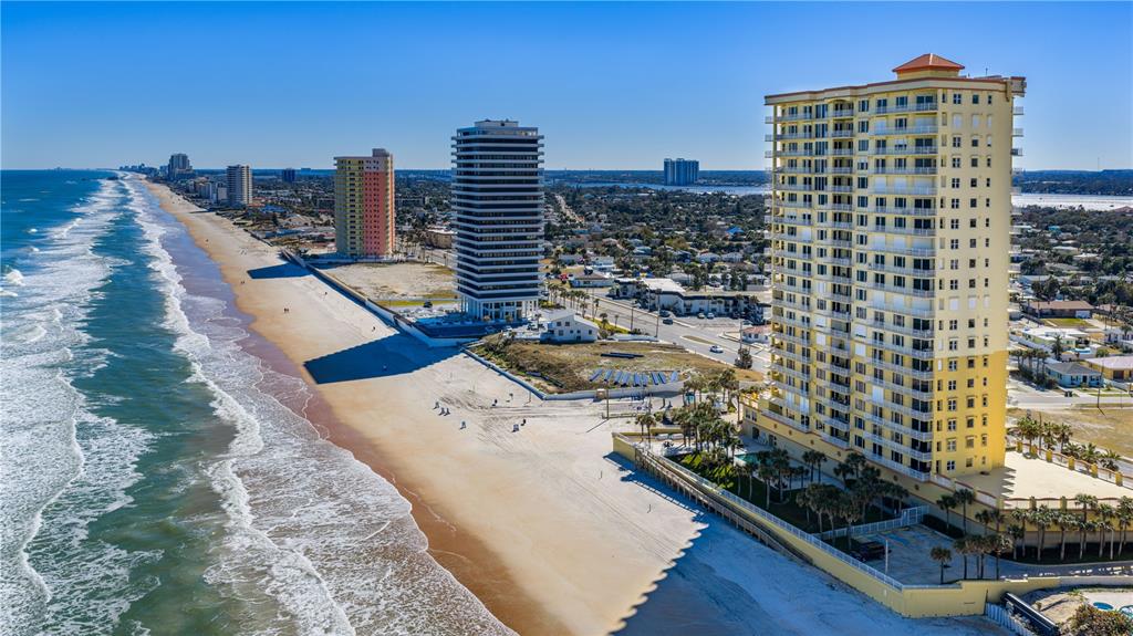 An aerial view of a sandy beach lined with several high-rise residential buildings — 2300 N ATLANTIC AVENUE UNIT 101, DAYTONA BEACH, FL