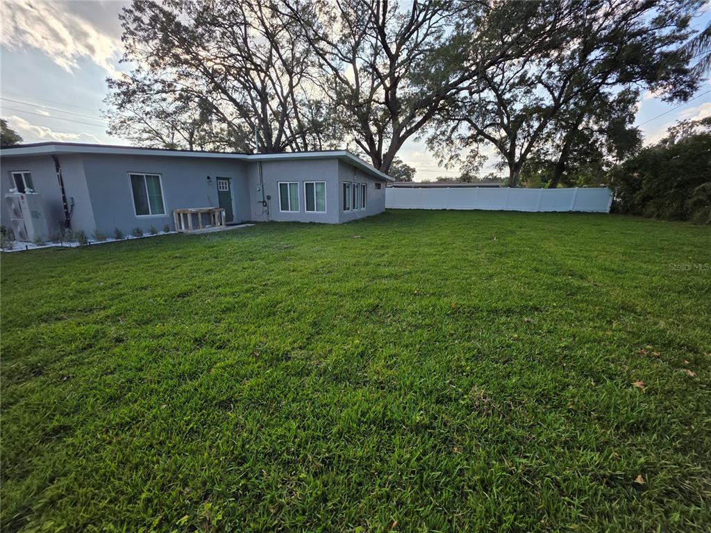 A gray house with a large backyard and a white vinyl fence — 1911 W AMELIA STREET, ORLANDO, FL