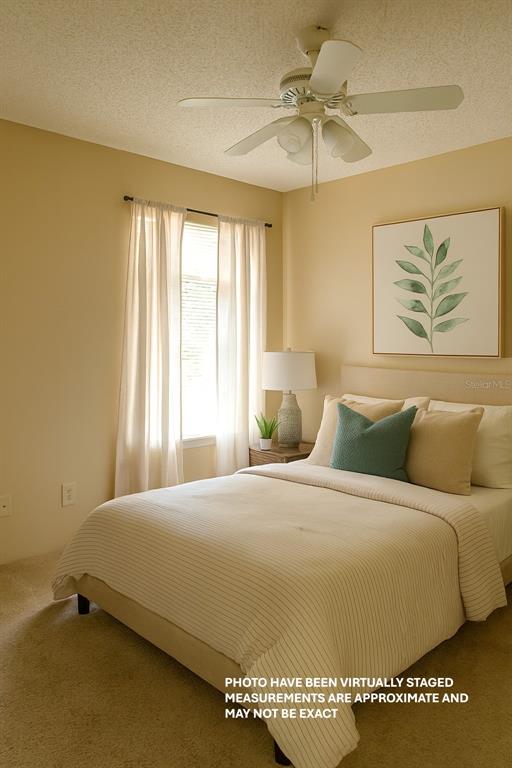 A bedroom features a bed with neutral bedding, a ceiling fan, and a framed leaf print — 351 LONE HILL DRIVE UNIT 306, ALTAMONTE SPRINGS, FL