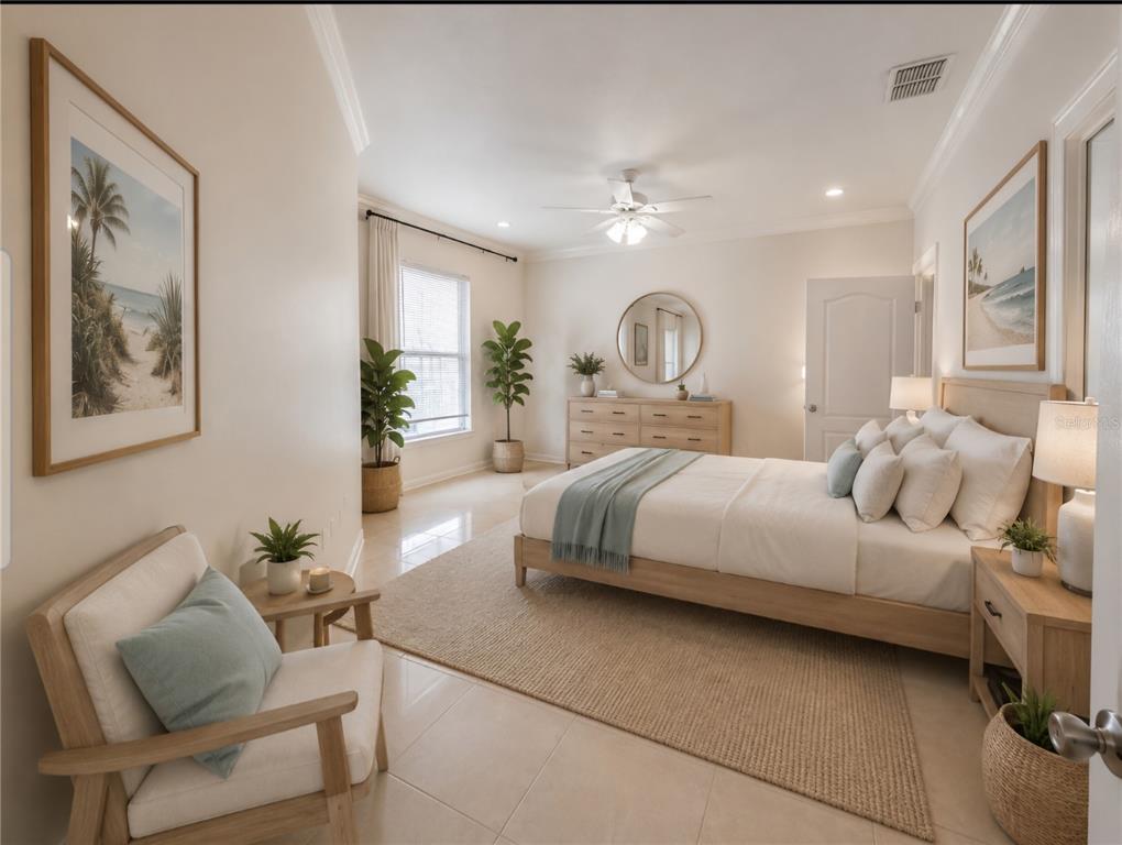 A bright bedroom features a bed, dresser, armchair, and coastal-themed wall art on tiled floors — 18058 VILLA CREEK DRIVE UNIT 18058, TAMPA, FL