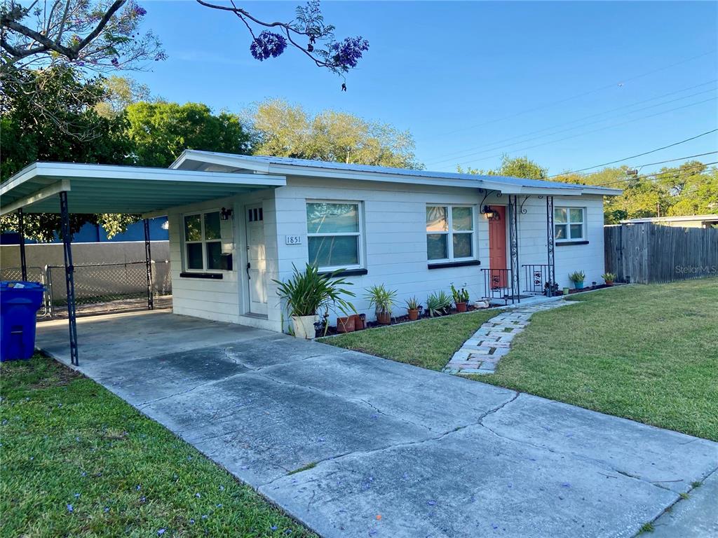 A single-story house with a white exterior, a carport, and a concrete driveway — 1851 50TH AVENUE N, ST PETERSBURG, FL