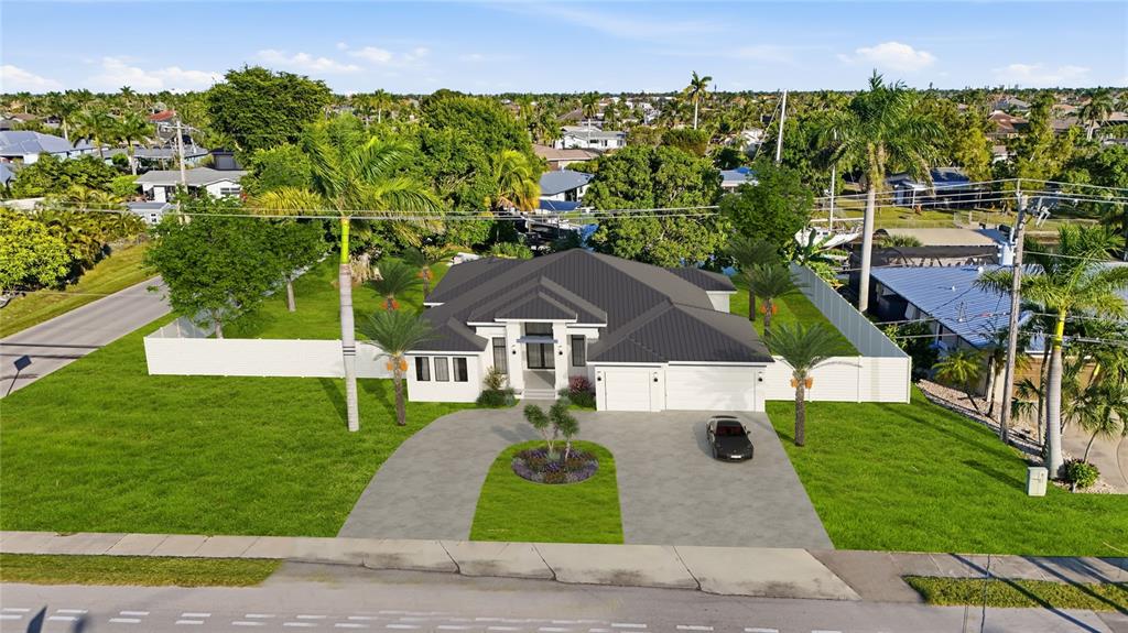 This is a digital rendering of a single-story house with a dark roof and driveway — 5229 PELICAN BOULEVARD, CAPE CORAL, FL