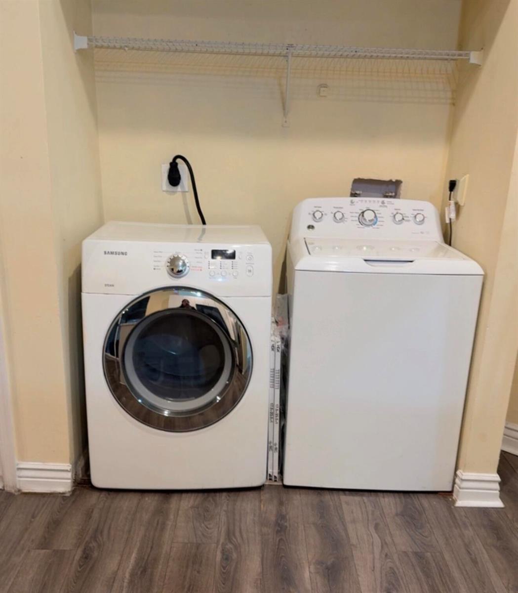 A laundry area features a white front-load Samsung dryer and a white top-load washing machine — 7640 Forest Green Ln, Boynton Beach FL 33436, BOYNTON BEACH, FL