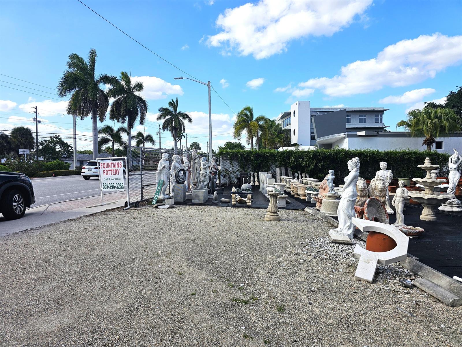 An outdoor lot displays various concrete statues, fountains, and pottery for sale — 3675 N Federal Highway, Boynton Beach FL 33435, BOYNTON BEACH, FL
