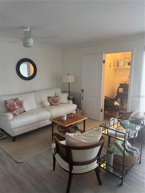 A living room features a white sofa, a wooden coffee table, and a rolling bar cart — 550 ORANGE DRIVE UNIT 3, ALTAMONTE SPRINGS, FL