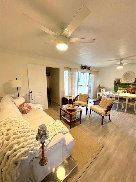 A living room features a white sofa, a ceiling fan, and an adjacent dining area — 550 ORANGE DRIVE UNIT 3, ALTAMONTE SPRINGS, FL