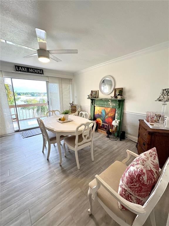 A dining area features a round white table, chairs, and a decorative fireplace mantel — 550 ORANGE DRIVE UNIT 3, ALTAMONTE SPRINGS, FL