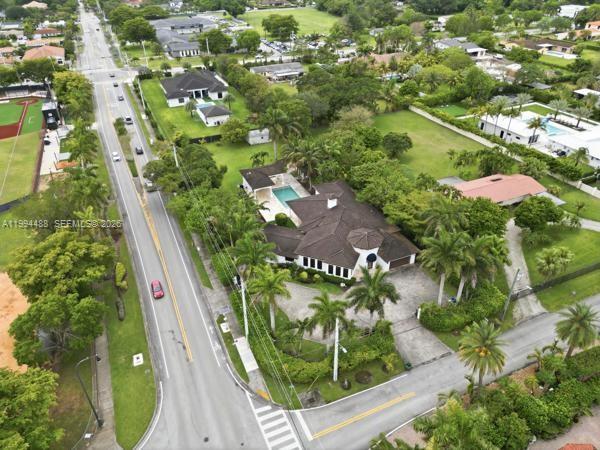 An aerial view shows a residential property with a swimming pool and lush landscaping — 6200 SW 97th Ave, Miami FL 33173, MIAMI, FL