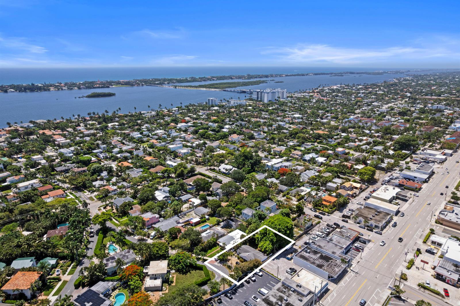 An aerial view shows a single-story house outlined in white, situated near a commercial street — 330 Marlborough Place, West Palm Beach FL 33405, WEST PALM BEACH, FL