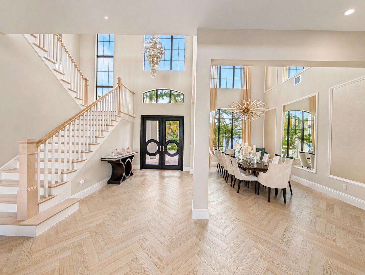 A grand foyer with a herringbone wood floor, staircase, and an adjacent formal dining room — 7080 NW 26th Way, Boca Raton FL 33496, BOCA RATON, FL