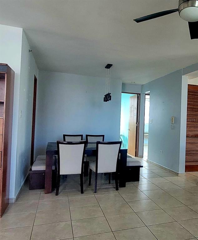 A dining area features a dark wood table with four chairs and a ceiling fan — 1400 JOSE DE DIEGO AVE COND PALACIOS DEL ESCORIAL UNIT 9-51, CAROLINA, PR