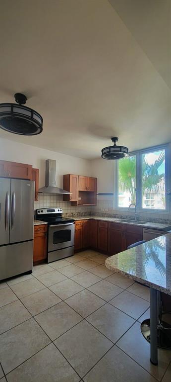 A kitchen with stainless steel appliances, wood cabinets, granite countertops, and tile flooring — 1400 JOSE DE DIEGO AVE COND PALACIOS DEL ESCORIAL UNIT 9-51, CAROLINA, PR