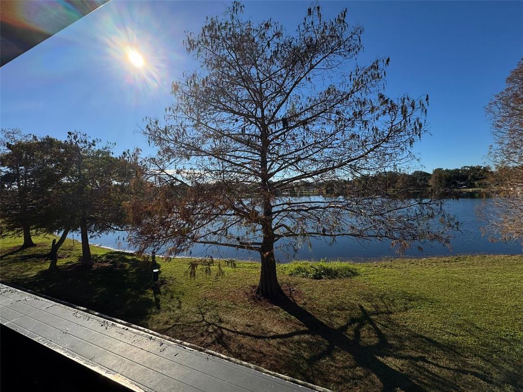 A view of a lake and trees from a balcony on a sunny day — 912 LAKE DESTINY ROAD UNIT G, ALTAMONTE SPRINGS, FL