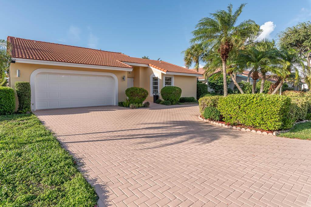 A single-story house with a tiled roof, a paved driveway, and manicured landscaping — 251 NW 69th Street, Boca Raton FL 33487, BOCA RATON, FL