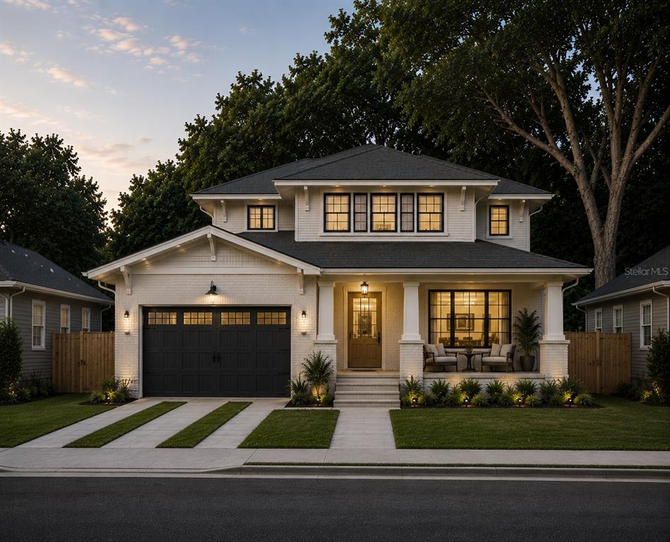 A two-story white brick house with a dark garage door and a front porch — 4608 W EL PRADO BOULEVARD, TAMPA, FL