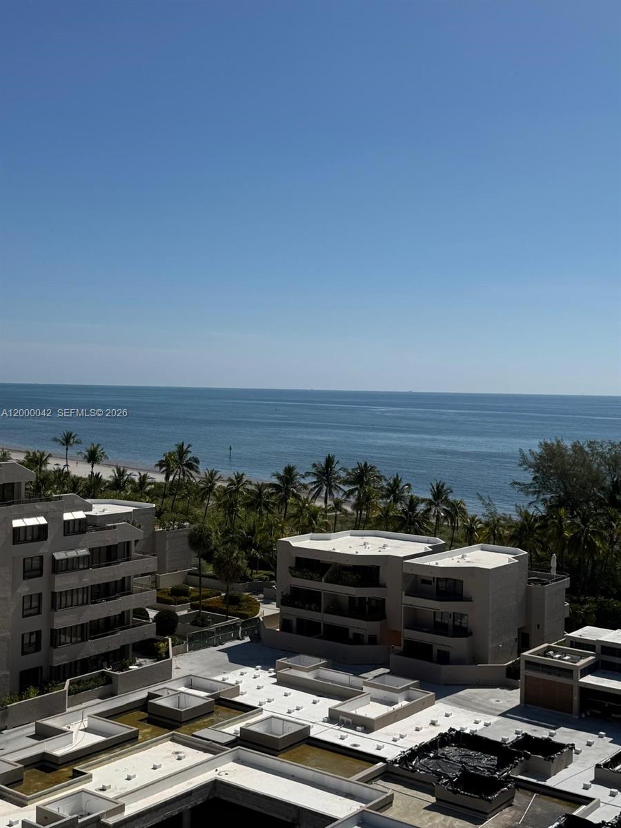 An elevated view shows modern apartment buildings overlooking a sandy beach and the ocean — 201 Crandon Blvd # 932, Key Biscayne FL 33149, KEY BISCAYNE, FL