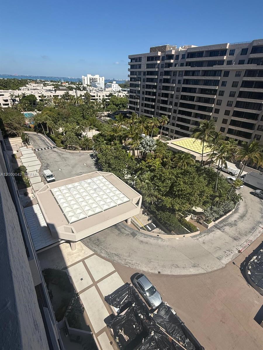 An elevated view shows a building entrance, a circular driveway, and surrounding tropical landscaping — 201 Crandon Blvd # 932, Key Biscayne FL 33149, KEY BISCAYNE, FL
