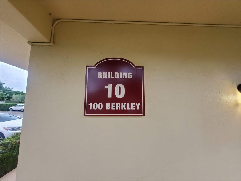 A sign on a beige exterior wall identifies the building as number 10 — 100 Berkley Road # 109, Hollywood FL 33024, HOLLYWOOD, FL