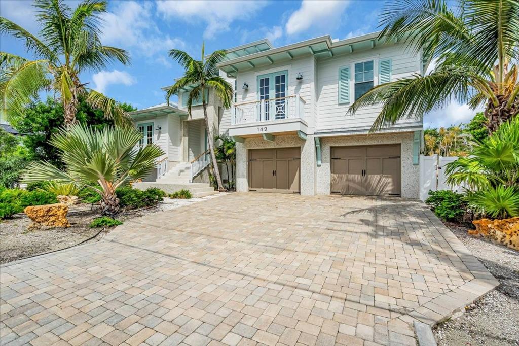 A two-story house with a paver driveway, two garage doors, and a second-floor balcony — 149 MCKINLEY DRIVE, SARASOTA, FL