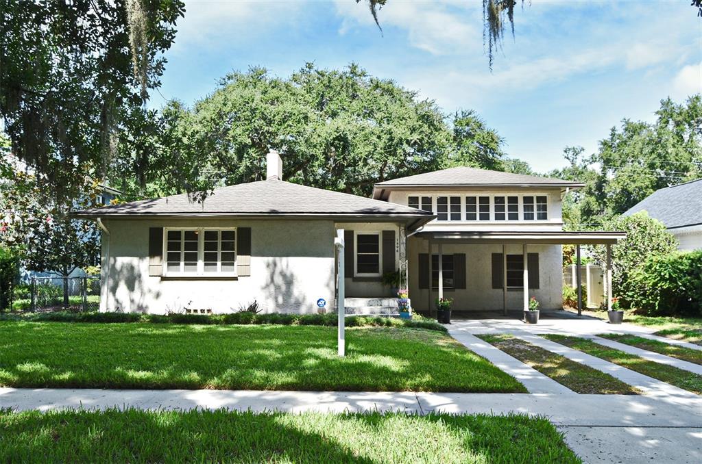 A single-story house with a stucco exterior, a front porch, and a concrete driveway — 1606 ORANGEWOOD AVENUE, ORLANDO, FL