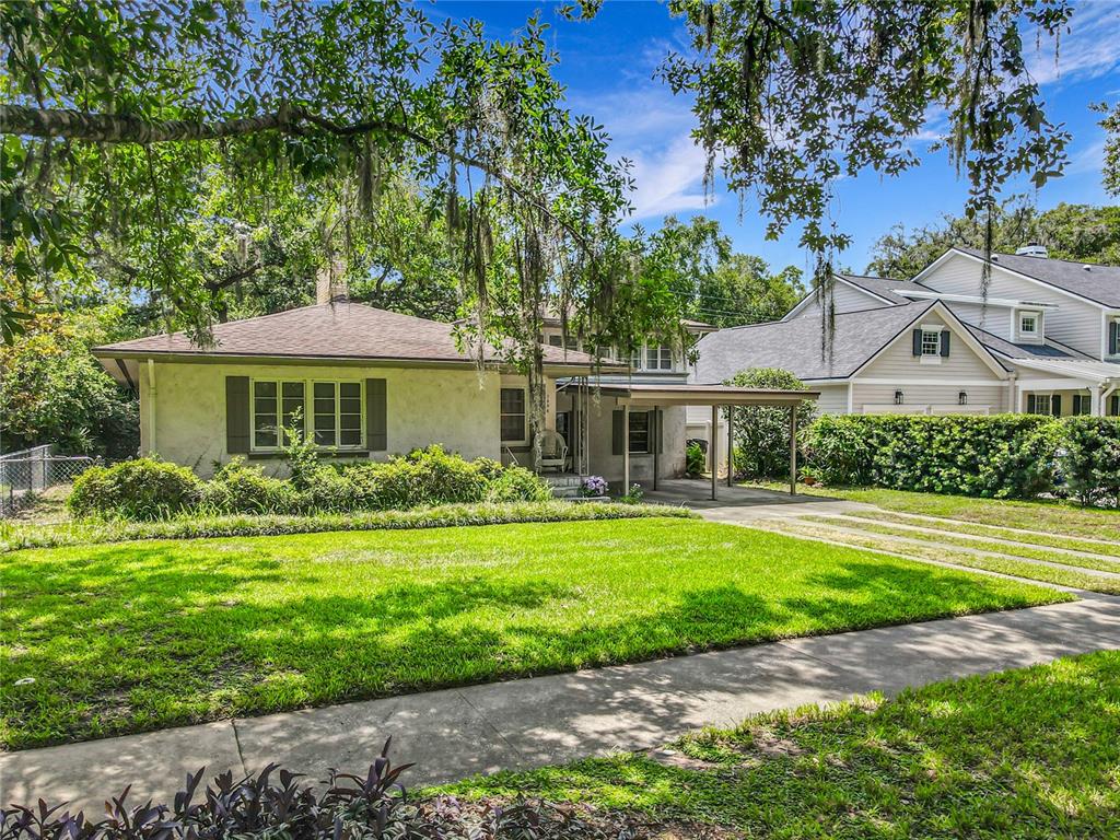 A single-story house with a carport and a large front lawn under mature trees — 1606 ORANGEWOOD AVENUE, ORLANDO, FL