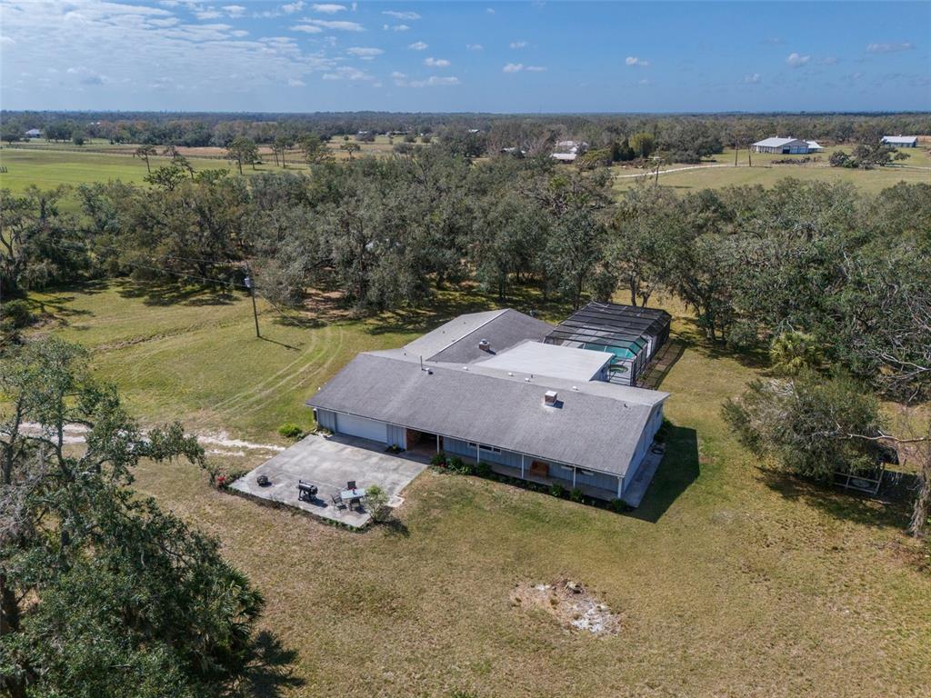 An aerial view of a single-story house with a screened pool and a concrete patio — 1510 LENA LANE, SARASOTA, FL