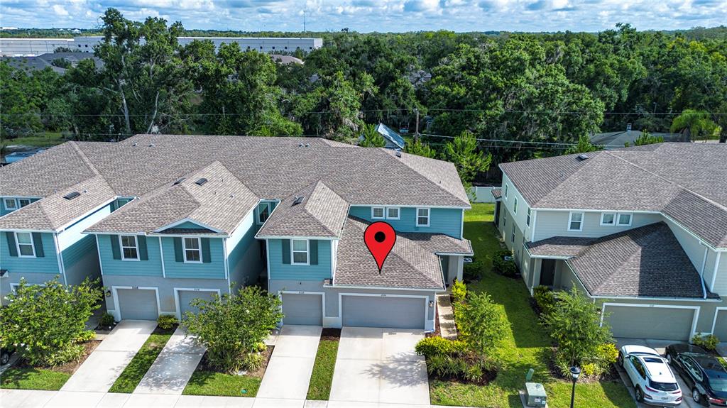 An aerial view of a multi-unit residential building with attached garages and shingled roofs — 2120 LACEFLOWER DRIVE, BRANDON, FL