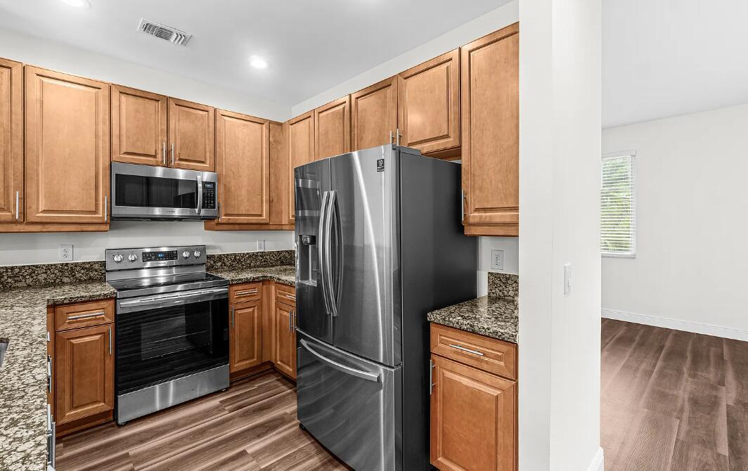 A kitchen features wood cabinets, granite countertops, and stainless steel appliances — 536 N West 39th Circle, Boca Raton FL 33431, BOCA RATON, FL