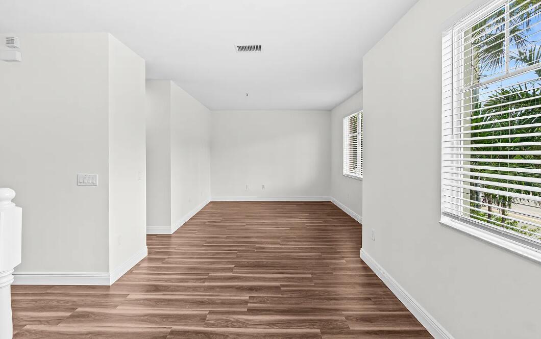 An empty room with white walls, wood-look flooring, and windows with white blinds — 536 N West 39th Circle, Boca Raton FL 33431, BOCA RATON, FL