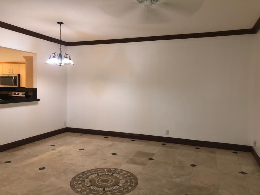 An empty dining room features tile flooring with a decorative medallion and dark crown molding — 5449 NW 90th Avenue, Sunrise FL 33351, SUNRISE, FL