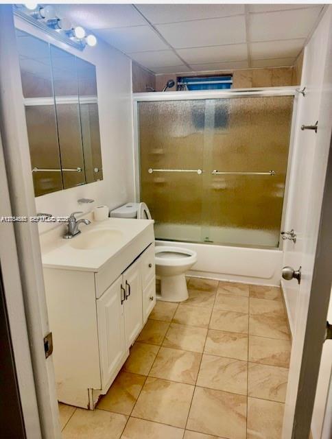 A bathroom features a white vanity, a toilet, and a shower-tub combination with sliding doors — 2000 Biarritz Dr # 407, Miami Beach FL 33141, MIAMI BEACH, FL