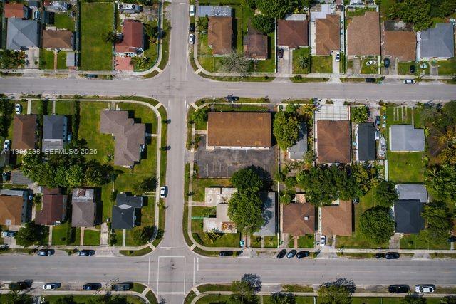 This is an aerial view of a residential neighborhood with houses, streets, and parking lots — 6891 NW 13th Ave, Miami FL 33147, MIAMI, FL