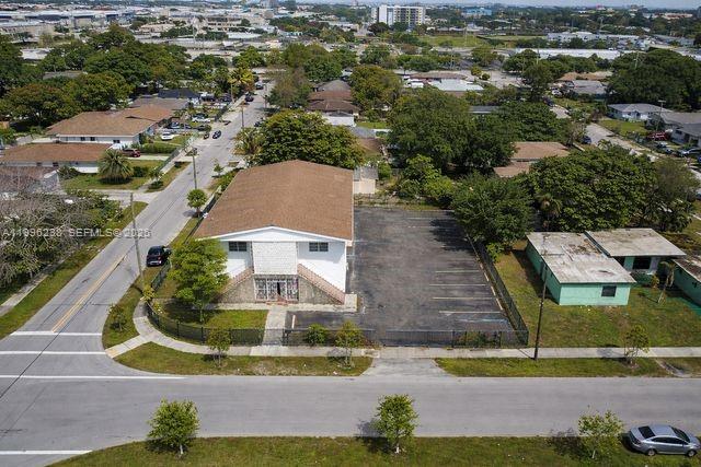 An aerial view shows a two-story building with a parking lot in a residential neighborhood — 6891 NW 13th Ave, Miami FL 33147, MIAMI, FL