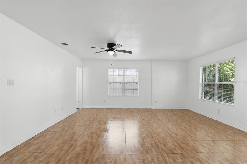 An empty room with white walls, tile flooring, a ceiling fan, and two windows — 820 ALTALOMA AVENUE, ORLANDO, FL