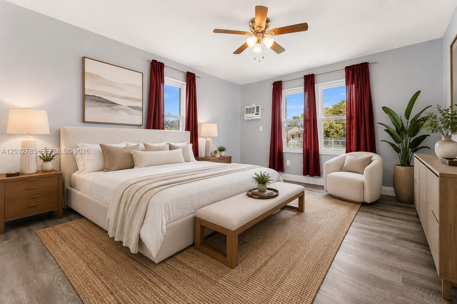 A bedroom features a king bed, a bench, a chair, and red curtains — 9301 NW 20th Ave, Miami FL 33147, MIAMI, FL